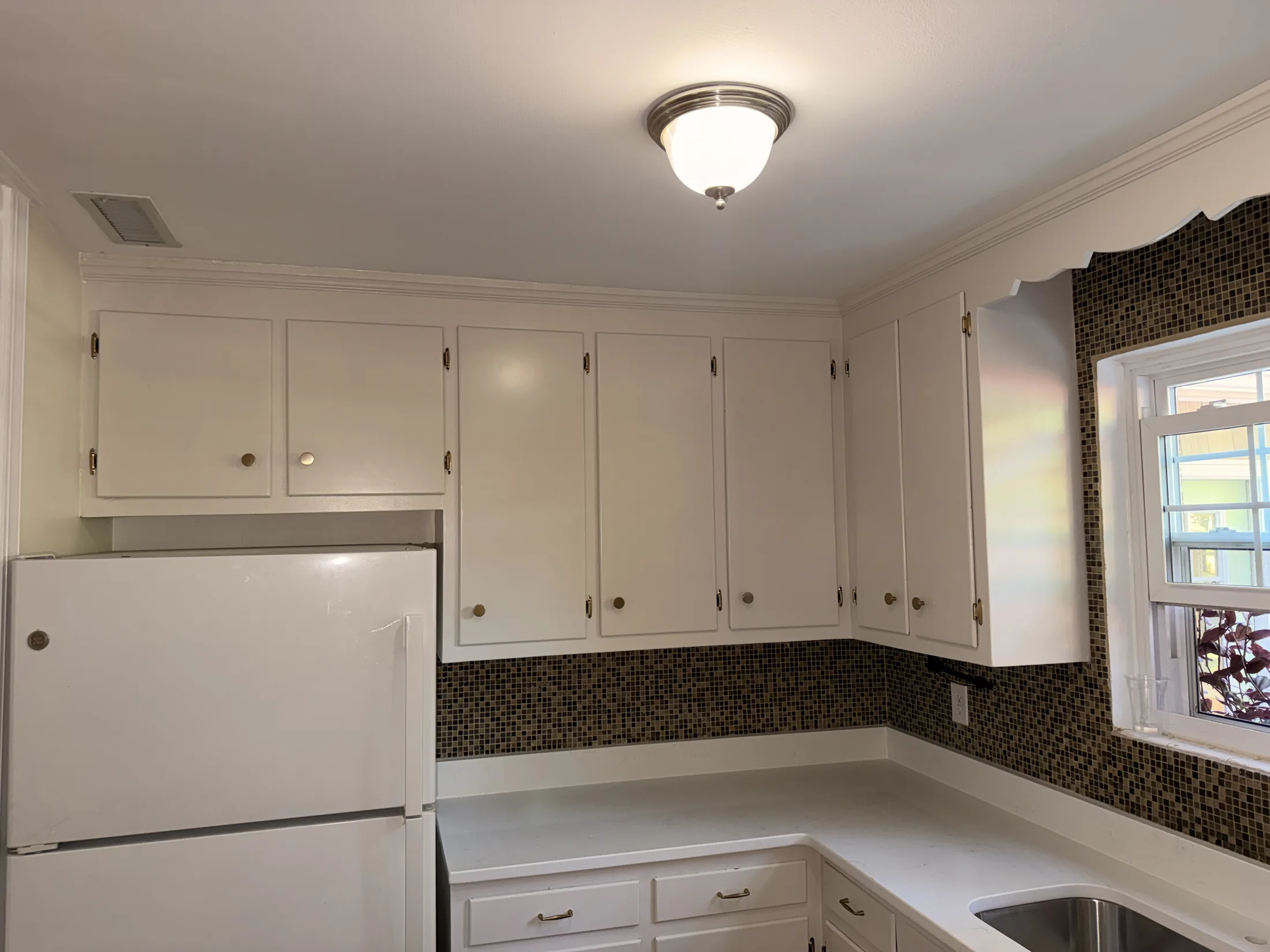 Completed upper kitchen cabinets with white finish