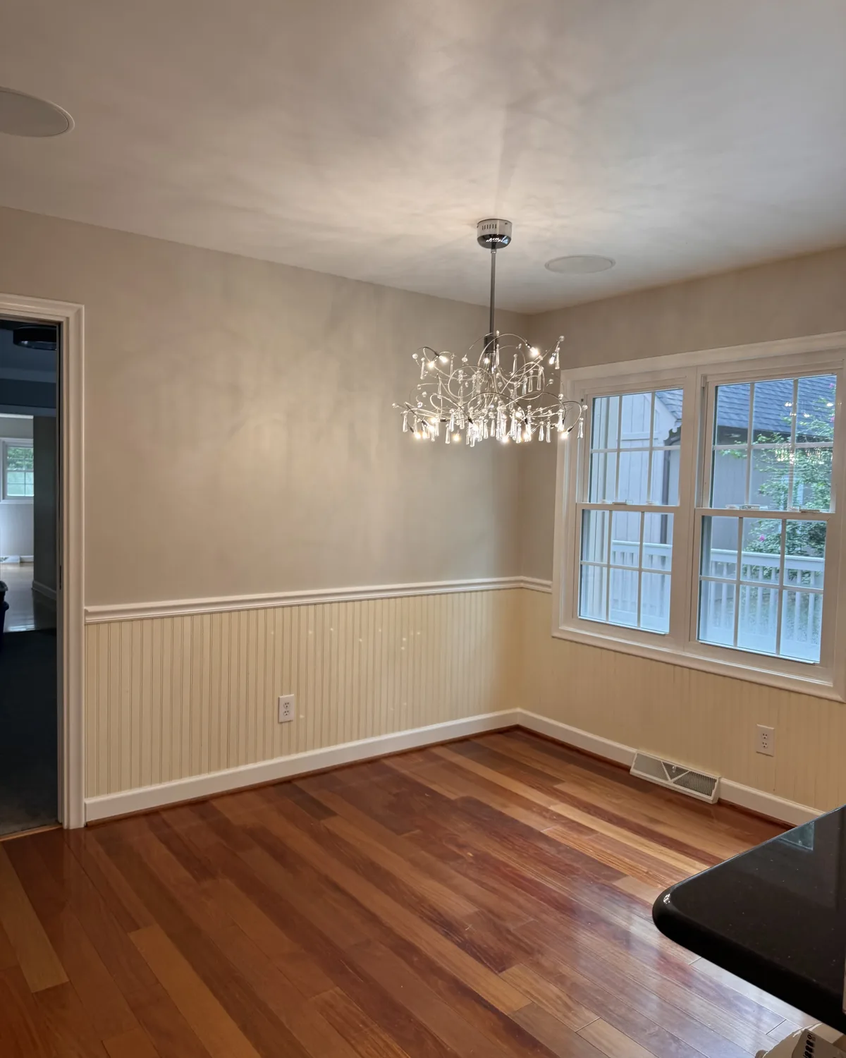 Dining room refreshed with soft neutral walls around the white trim