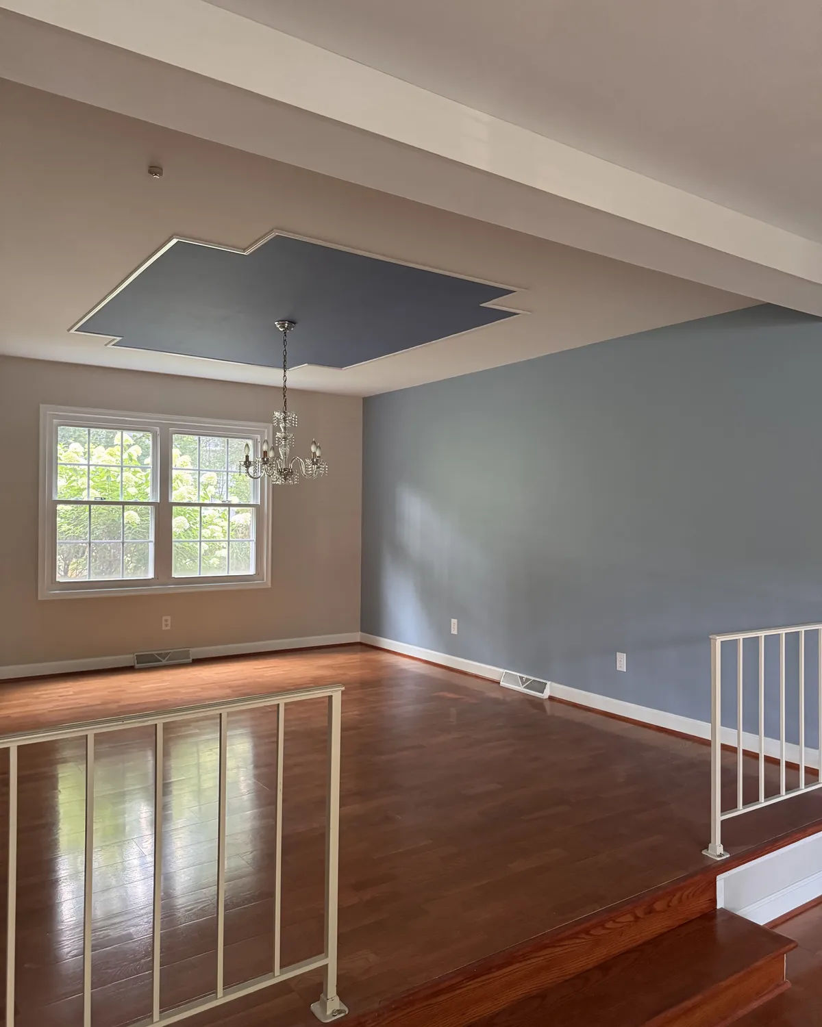 Living room finished with neutral walls and a deep blue-gray architectural accent
